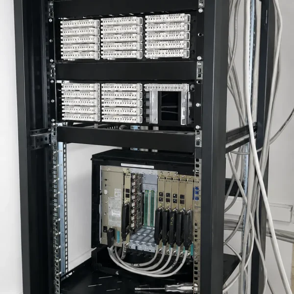 A tall vertical server telecom rack in a plain roo result 1 600x600